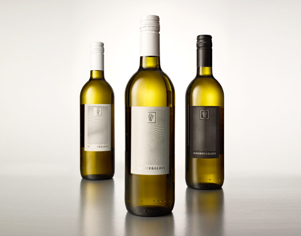 three elegant wine bottles with black and white labels printed with hot foil stamping